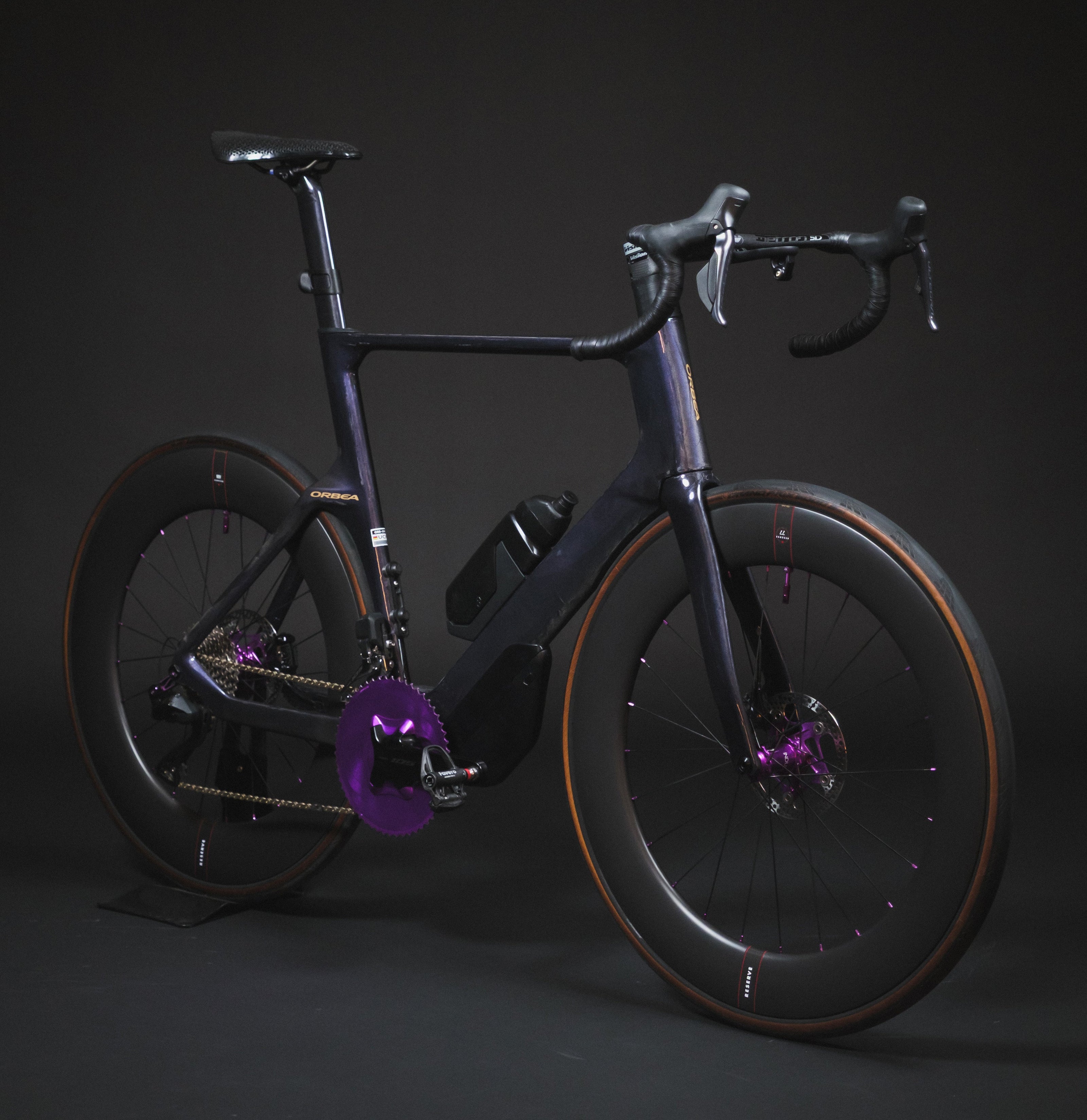 Modern bicycle with a dark frame and purple accents on a black background